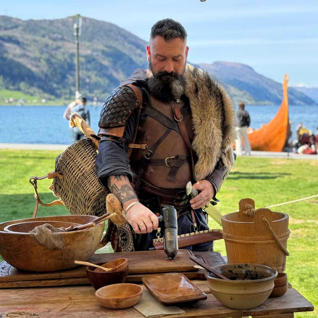 Man in Viking attire uses Hedgehog Dryer TurboVAC to vacuum crumbs on table